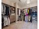 Well-organized walk-in closet with ample shelving, hanging space, and stylish lighting at 5029 Tarry Glen Dr, Suwanee, GA 30024