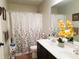 Bathroom with tiled floor and a double sink vanity with a decorative shower curtain at 207 Birchwood Dr, Loganville, GA 30052