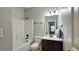 Bathroom featuring a shower and tub combo, a vanity and a dark faucet at 207 Birchwood Dr, Loganville, GA 30052