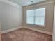 Upstairs bedroom featuring carpeting, natural light, and white trim at 207 Birchwood Dr, Loganville, GA 30052