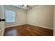 A cozy bedroom with hardwood floors and a ceiling fan offers comfort and style at 207 Birchwood Dr, Loganville, GA 30052