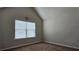 A carpeted bedroom with neutral walls and a window with horizontal blinds at 207 Birchwood Dr, Loganville, GA 30052