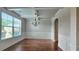 Bright dining room featuring a large window, chandelier, wainscoting, and coffered ceilings at 207 Birchwood Dr, Loganville, GA 30052