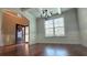 Inviting entryway with hardwood floors, a transom window, wainscoting, coffered ceilings, and a wreath on the front door at 207 Birchwood Dr, Loganville, GA 30052