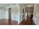 Open-concept entryway with hardwood floors, archways, and wainscoting, leading to multiple rooms in the home at 207 Birchwood Dr, Loganville, GA 30052