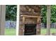 Exterior patio area featuring a stone fireplace with a wood mantle at 207 Birchwood Dr, Loganville, GA 30052