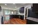 Open-concept kitchen with dark cabinets, granite countertops, stainless steel appliances, and an undermount sink at 207 Birchwood Dr, Loganville, GA 30052