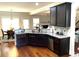 Modern kitchen featuring dark cabinets, stainless steel appliances, and granite countertops at 207 Birchwood Dr, Loganville, GA 30052