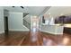 Large open-concept living room featuring hardwood floors, a staircase, an archway, and access to the kitchen at 207 Birchwood Dr, Loganville, GA 30052
