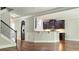 Open-concept living room and kitchen area with hardwood floors, a staircase, and an open layout at 207 Birchwood Dr, Loganville, GA 30052