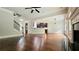 Expansive living room with hardwood floors, open access to the kitchen, a staircase, and a fireplace at 207 Birchwood Dr, Loganville, GA 30052