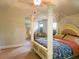 Light-filled main bedroom featuring a canopy bed with decorative pillars and a seating area at 207 Birchwood Dr, Loganville, GA 30052