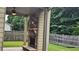 Covered patio showcases a stone fireplace with a mantle, providing a cozy outdoor living space at 207 Birchwood Dr, Loganville, GA 30052