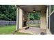Covered patio featuring stone fireplace, stained concrete, ceiling fan, and wooden privacy fence at 207 Birchwood Dr, Loganville, GA 30052
