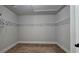 Spacious walk-in closet with carpet floors and clothing racks for great storage at 207 Birchwood Dr, Loganville, GA 30052