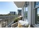 Spacious balcony with outdoor seating and views of the city skyline and lush greenery at 2500 Peachtree Nw Rd # 605S, Atlanta, GA 30305