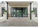 Elegant building entrance featuring brick pathway and black framed glass doors and windows at 2500 Peachtree Nw Rd # 605S, Atlanta, GA 30305