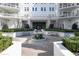 A tranquil courtyard showcases a central fountain, elegant landscaping, and cozy benches amidst a serene building facade at 2500 Peachtree Nw Rd # 605S, Atlanta, GA 30305