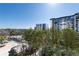 Exterior shot showing building with balconies, surrounded by green trees on a clear, sunny day at 2500 Peachtree Nw Rd # 605S, Atlanta, GA 30305