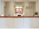 An elegant reception area, featuring a marble counter, framed artwork, and subtle lighting, exudes sophistication at 2500 Peachtree Nw Rd # 605S, Atlanta, GA 30305