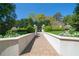 Elegant brick walkway lined with manicured greenery, leading to a serene and beautifully landscaped area at 2500 Peachtree Nw Rd # 605S, Atlanta, GA 30305