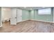 Finished basement with laminate floors, neutral paint and recessed lighting at 2722 Oswood Dr, Tucker, GA 30084