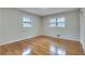 Bright bedroom with hardwood floors and double windows overlooking a lush landscape at 2722 Oswood Dr, Tucker, GA 30084