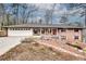 Charming brick home featuring a well-maintained yard, a two-car garage, and inviting front porch at 2722 Oswood Dr, Tucker, GA 30084