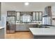 Contemporary kitchen equipped with stainless steel appliances, white countertops, and ample cabinet space at 2722 Oswood Dr, Tucker, GA 30084