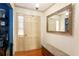 Inviting entryway featuring hardwood floors, a decorative mirror, and a classic front door at 7121 Forest Se Dr, Covington, GA 30014