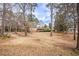 View of the traditional home surrounded by mature trees in a spacious yard at 7121 Forest Se Dr, Covington, GA 30014