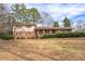 Charming two-story brick home with a well-maintained lawn and mature landscaping at 7121 Forest Se Dr, Covington, GA 30014