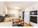 Spacious kitchen featuring white cabinets, wooden countertops, a cooktop island, and stainless steel appliances at 7121 Forest Se Dr, Covington, GA 30014