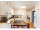 Bright kitchen featuring white cabinets, wooden countertops, a cooktop island, and stainless steel appliances at 7121 Forest Se Dr, Covington, GA 30014