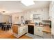 Functional kitchen featuring wood countertops, white cabinets, and hardwood floors at 7121 Forest Se Dr, Covington, GA 30014