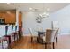 Open-concept dining space with a glass table, adjacent kitchen bar, and stainless steel appliances at 1253 Caroline Ne St, Atlanta, GA 30307