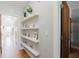 Hallway features modern floating shelves with decorative accents and hardwood floors at 1253 Caroline Ne St, Atlanta, GA 30307