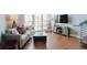 Cozy living room featuring a comfortable couch, entertainment center, and walkout to balcony at 1253 Caroline Ne St, Atlanta, GA 30307