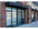 Exterior view of a brick building storefront with large glass windows and dark awning at 1253 Caroline Ne St, Atlanta, GA 30307