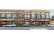 Street view of the building and surrounding storefronts with parked cars at 1253 Caroline Ne St, Atlanta, GA 30307
