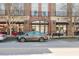 Street view of a brick building with retail spaces, including a gray car parked nearby at 1253 Caroline Ne St, Atlanta, GA 30307