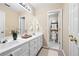 Bathroom with dual sinks, white cabinets, and a separate toilet and shower room for added privacy at 514 Lovinggood Ct, Woodstock, GA 30189