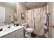 Neutral bathroom featuring a shower-tub combination, a single sink vanity, and wood-look flooring at 514 Lovinggood Ct, Woodstock, GA 30189
