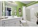 Bright bathroom features a white vanity and a shower-tub combination with white tile surround at 514 Lovinggood Ct, Woodstock, GA 30189