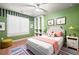Colorful bedroom features striped wallpaper, white furniture, and a bright rug at 514 Lovinggood Ct, Woodstock, GA 30189