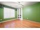 Bedroom with wood floors, a large window and green walls at 514 Lovinggood Ct, Woodstock, GA 30189