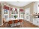 Sunlit breakfast nook with a marble countertop island and modern pendant lighting at 514 Lovinggood Ct, Woodstock, GA 30189