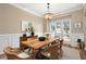 Dining room features a wooden table, modern light fixture, and large window at 514 Lovinggood Ct, Woodstock, GA 30189