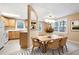 Dining area with a table, seating for six, windows, and is adjacent to the kitchen and breakfast bar at 514 Lovinggood Ct, Woodstock, GA 30189