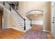 Elegant foyer with hardwood floors, staircase, and traditional decor at 514 Lovinggood Ct, Woodstock, GA 30189